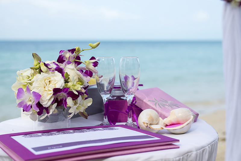 A table on the beach with a wedding decoration